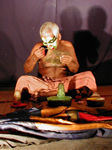 Getting made up as  a "Pacca," one of seven Kathakalli characters.  The Pacca ("green") is the noble hero whose face is painted bright green and framed in a white bow-shaped sweep from ears to chin. Heroes such as Rama, Laksmana, Krishna, Arjuna, and Yudhisthira fall into this category. 