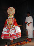 The dancers enact the story being told by the drummer with cymbals, using a repetoire of eye movements and patterned gestures.  This man translated the story into English.