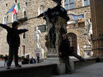 Silly children on the Loggia, just before the police woman told them not to touch the sculpture.  They obeyed the policewoman and not their mother. 