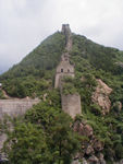 The beginning of our hike.  To the left is a dam for a reservoir.  In the old days, the wall had a gate in it here.  The Wall is over 4000 miles long, We hike several miles worth.  In about 221 BC Shih huang-ti, the first emperor and "Mr. Terra-cotta warrior," unified China. He removed most of the fortifications set up between the previous states and, beginning in about 214 BC, linked others into the "10,000 Li Long Wall" (2 li equal approximately 0.6 mile [1 km]). After Shih huang-ti's death, the Ch'in dynasty went with him, and the wall was left largely ungarrisoned and fell into disrepair.