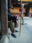 Handsome man with spinning prayer wheel. 