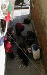 Monks playing cards in a sidestreet.