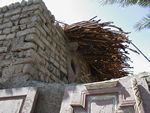 The roof and pigeon roosts.  The house recently got electricity and now has a tv and refrigerator.  The roof is gives shade, but when it rains - every few years or so - things get wet.