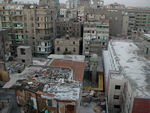 The view from our window.  On the top of many buildings are incredible collections of rubble.  On the tops of others are living places - sometimes part of the building and sometimes constructed on the roof.  We saw kids riding bikes ten stories up and women tending chickens.  