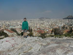 Tote on the Areopagus or Hill of Ares.  This is the spot in which a jury of gods spared Ares from execution for the murder of Poseidon's son. Homocide trials were heard on this hill for ages.  The Supreme Court of Greece is still called the Areopagus.  To his left is the big hill we climbed later in the day, Mt. Lycavittus