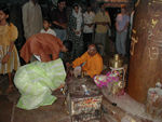 End of the puja at the Shiva Temple in Khajuraho.  On the right is the a huge lignam.  The base makes a yoni shape.  The puja is very impressive and well attended.  Bells clang, people chant and clap.  Many kiss and bow to the lingam and yoni.  It's hard to describe how exotic and different the whole thing is.